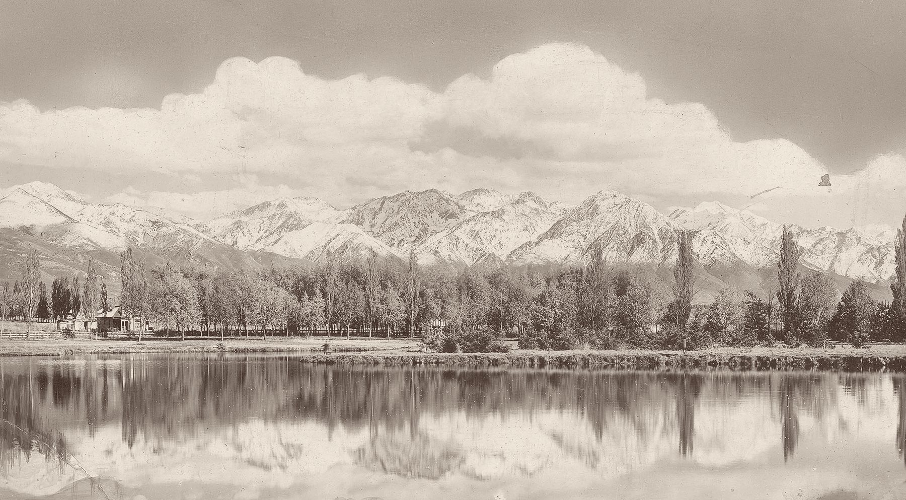 An 1880s photograph of the snow-covered Wasatch Range reflected in the pond at Liberty Park